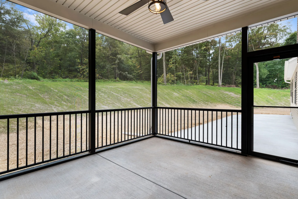 Outdoor screened-in porch with ceiling fan in a Rockville Estates home by Yingst Building Group in Marysville, Pennsylvania