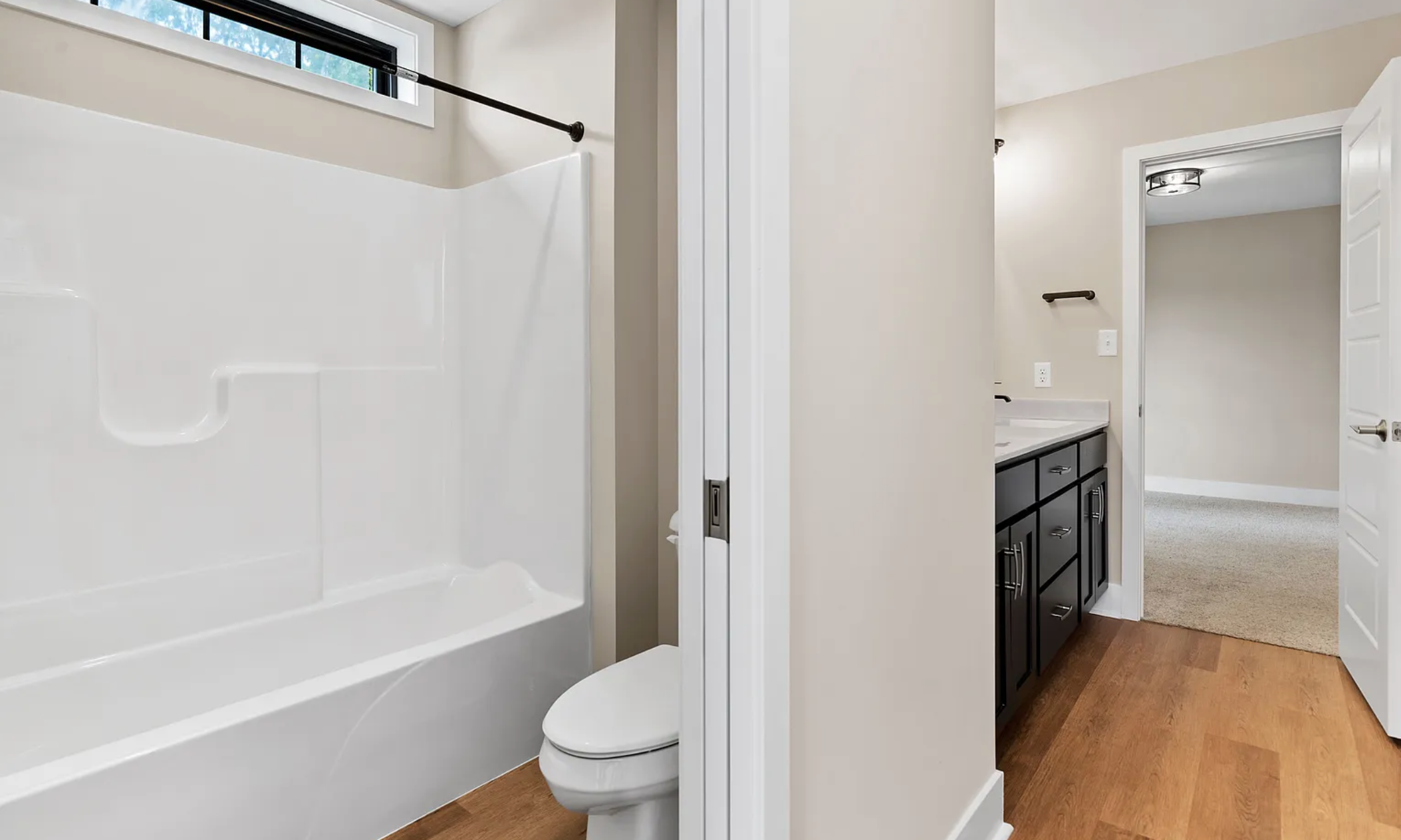 Full bathroom with bathtub, toilet, and vanity in a Rockville Estates home by Yingst Building Group