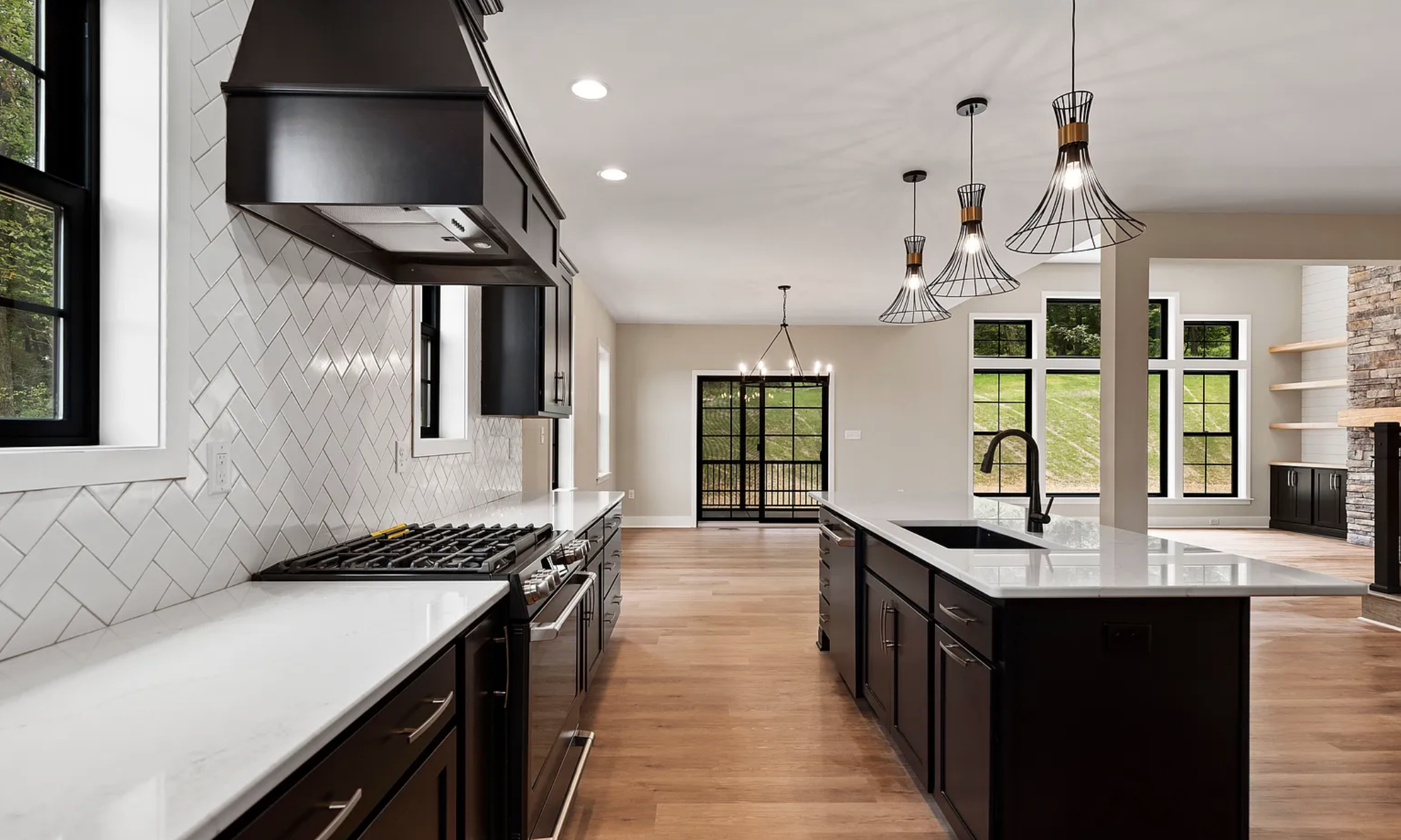 Full view of modern kitchen with island and open floor plan layout in a Rockville Estates home by Yingst Building Group