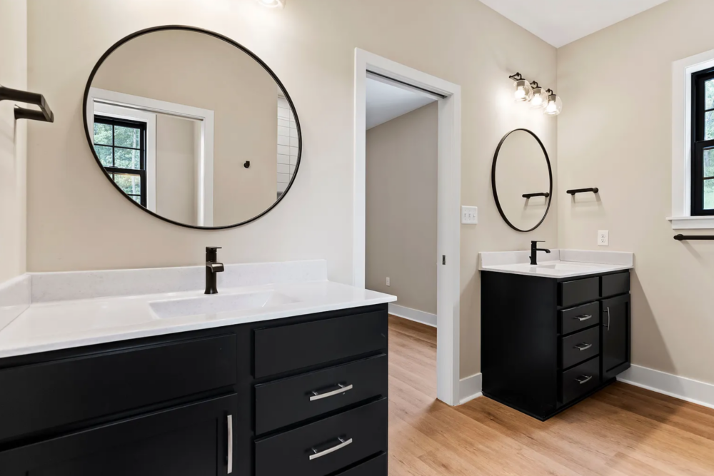 Primary suite bathroom with double vanity and modern finishes in a Rockville Estates home by Yingst Building Group